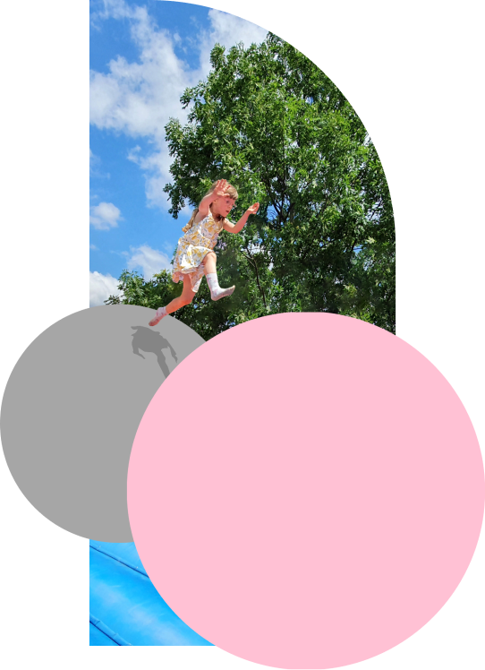 Girl jumping from gray ball to pink one